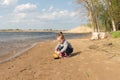 Child plays with toy car truck on the beach Royalty Free Stock Photo