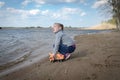 Child plays with toy car truck on the beach Royalty Free Stock Photo