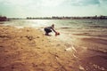 Child plays with toy car truck on the beach Royalty Free Stock Photo