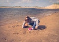Child plays with toy car truck on the beach Royalty Free Stock Photo