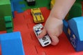 A child plays with a toy police car Royalty Free Stock Photo