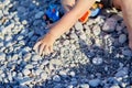 A child plays with toys and pebbles on the beach. The concept of recreation, play and the development of children& x27;s Royalty Free Stock Photo