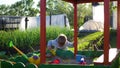 The child plays with the toys in the sandbox.Summer Sunny day