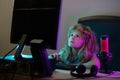 Child plays a video game on the pc computer screen. A pretty child learns a lesson using a desktop computer at home Royalty Free Stock Photo