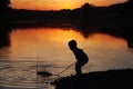 Child plays in water at sunset Royalty Free Stock Photo