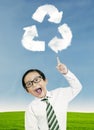 Child pointing at recycle symbol