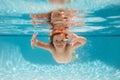 Child in pool in summer day. Kid swimming in pool underwater. Child boy swim under water in sea. Royalty Free Stock Photo