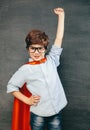 Child portraitCheerful smiling little boy against  chalkboard. Looking at camera. School concept Royalty Free Stock Photo