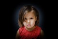 Child portrait in dark background. cute little girl