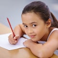 Child, portrait and education of student taking notes in classroom for knowledge and development. Serious, girl and Royalty Free Stock Photo