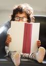 Child, portrait or glasses book read for fun education, learning or childhood development knowledge. Little girl, face Royalty Free Stock Photo