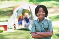 Child, portrait and happy on adventure at campground, joy and relaxing on vacation or holiday. Black male person Royalty Free Stock Photo