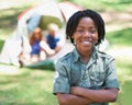 Child, portrait and smile on adventure at campground, happy and relaxing on vacation or holiday. Black male person Royalty Free Stock Photo