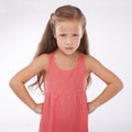 Child, portrait and unhappy grumpy in studio or bad mood discipline or development, trouble or angry. Female person