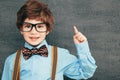 Child portraitCheerful smiling little boy against  chalkboard. Looking at camera. School concept Royalty Free Stock Photo