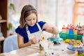 Child at pottery wheel. Kids arts and crafts class