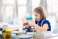 Child at pottery wheel. Kids arts and crafts class