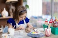 Child at pottery wheel. Kids arts and crafts class