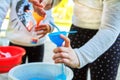 Child pour colored sand in the bottle