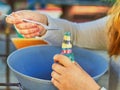 Child pour colored sand in the bottle