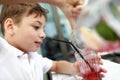 Child pouring fruit drink on terrace