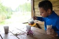 Child pouring herbal tea Royalty Free Stock Photo