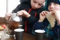 Child pouring herbal tea Royalty Free Stock Photo