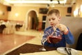 Child pouring juice in restaurant