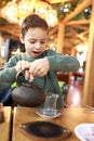 Child pouring tea into turkish glass