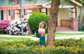 Child pouring water on the trees. Cute little boy watering flowers with watering can Royalty Free Stock Photo