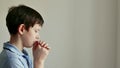 child pray. prayer believe concept. little boy folding his hands at home praying for faith in god. American a kid pray Royalty Free Stock Photo