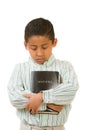 Child Praying While Hugging Bible Royalty Free Stock Photo