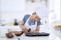 Child preparing chocolate dough on the mold