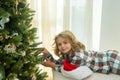 Child preparing for the Christmas and New Year holidays. Child with Christmas present. Kid Christmas tree. Little boy Royalty Free Stock Photo