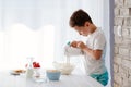 Child preparing cookies in kitchen