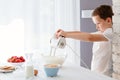 Child preparing cookies in kitchen