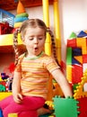 Child preschooler and construction set in playroom