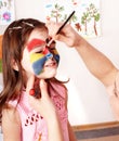 Child preschooler with face painting. Royalty Free Stock Photo