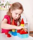 Child preschooler play wood block .