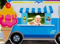 Child pretends to sell ice cream from an ice cream van