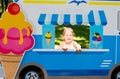 Child pretends to sell ice cream from an ice cream van
