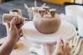Child in the process of decorating the clay vase. Children pottery studio. Royalty Free Stock Photo