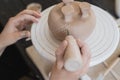 Child in the process of decorating the clay vase. Children pottery studio. Royalty Free Stock Photo