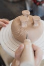 Child in the process of decorating the clay vase. Children pottery studio. Royalty Free Stock Photo