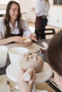 Child in the process of decorating the clay vase. Children pottery studio. Royalty Free Stock Photo