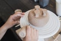 Child in the process of decorating the clay vase. Children pottery studio. Royalty Free Stock Photo