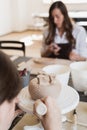 Child in the process of decorating the clay vase. Children pottery studio. Royalty Free Stock Photo