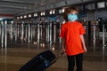 A child in a protective mask at the airport. Traveling during the Covid 19 coronaviruse. Social lockdown in US, America