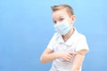 a child in a protective mask was given a vaccine against the disease, coronavirus or covid-19 Royalty Free Stock Photo