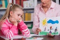 Child psychologist discusses drawing a little girl Royalty Free Stock Photo